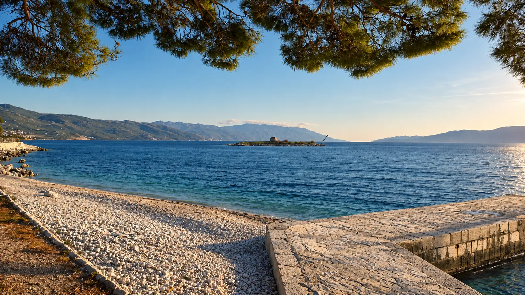 Editorial view of a pine-fringed Adriatic shore
